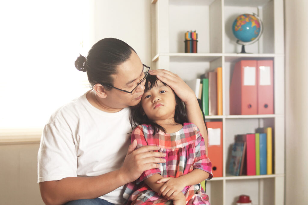 Teacher comforting child.