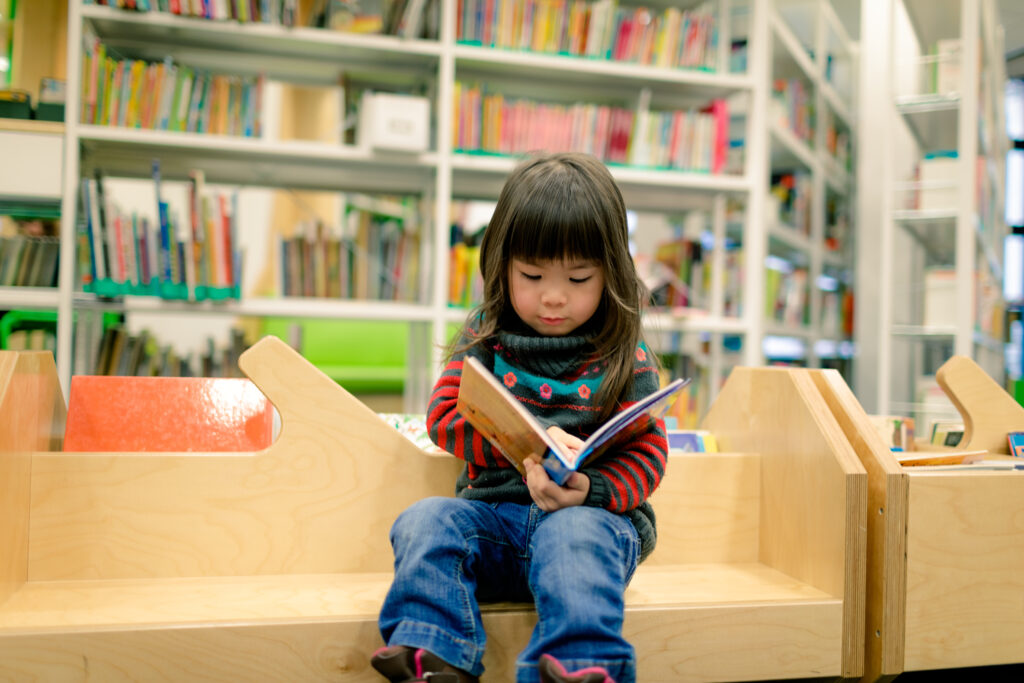 Young child reading a book.