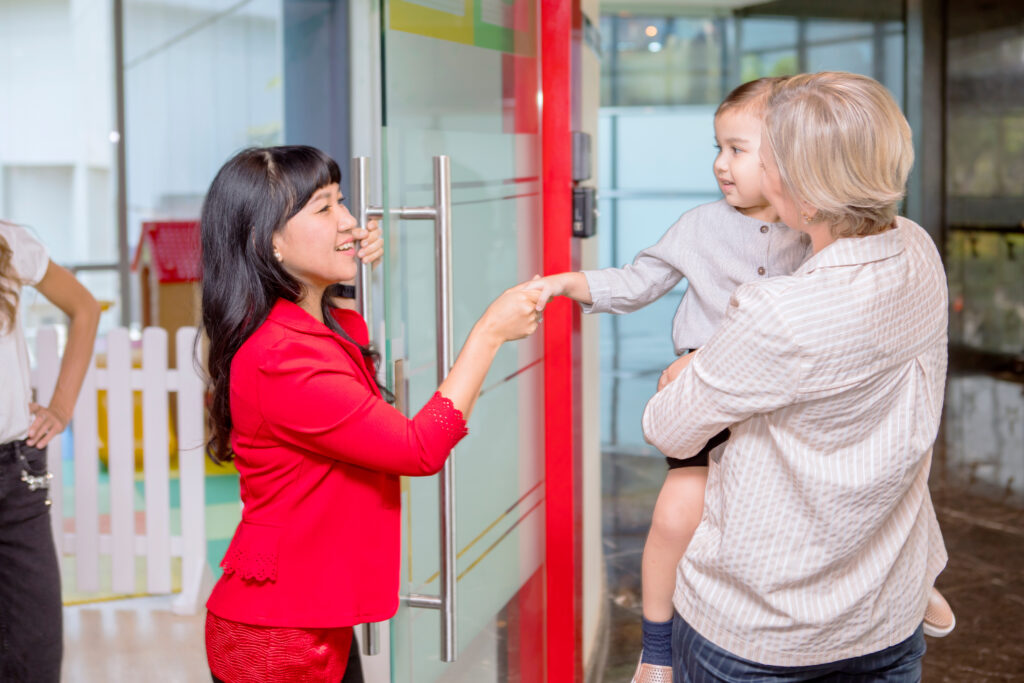 Parent and teacher with a child.