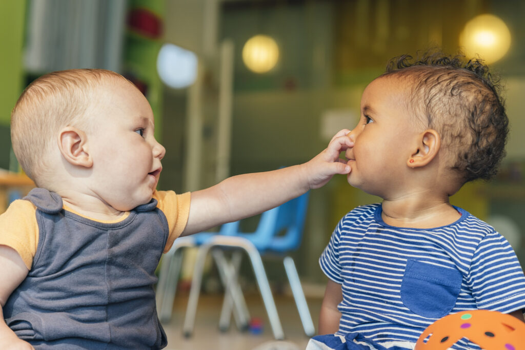 Two babies playing.