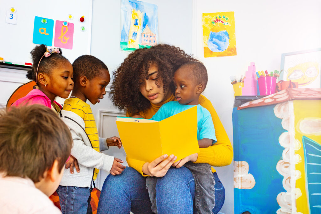 Teacher reading to young children.