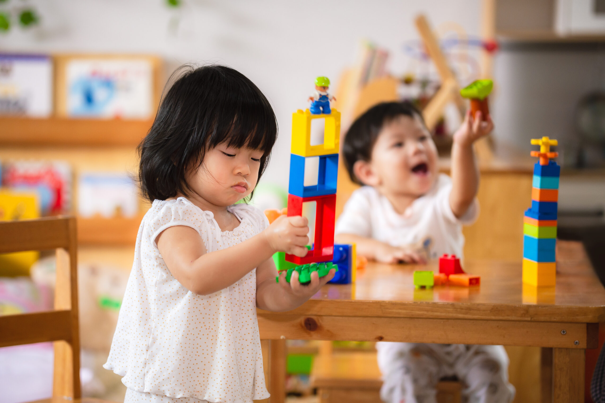 Two children playing with blocks.