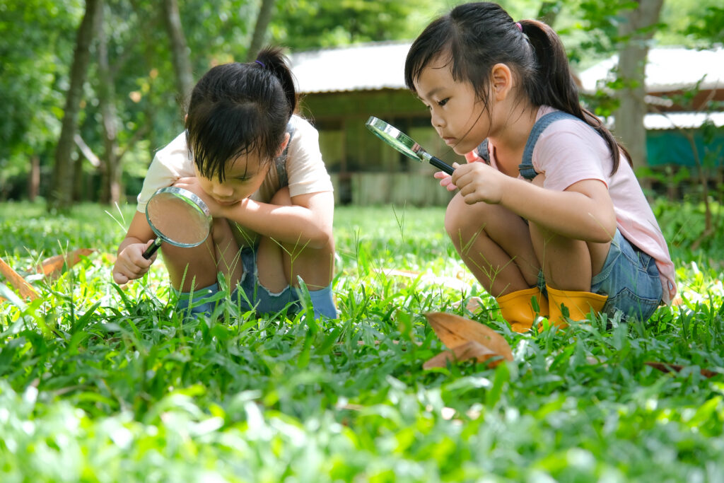 Two children play outside.