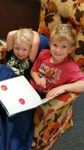 two-kids-in-chair-reading